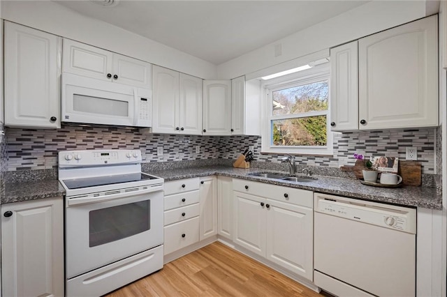 kitchen featuring a sink, white appliances, light wood-style floors, and white cabinets