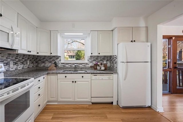 kitchen featuring white cabinetry, white appliances, light wood-style floors, and a sink