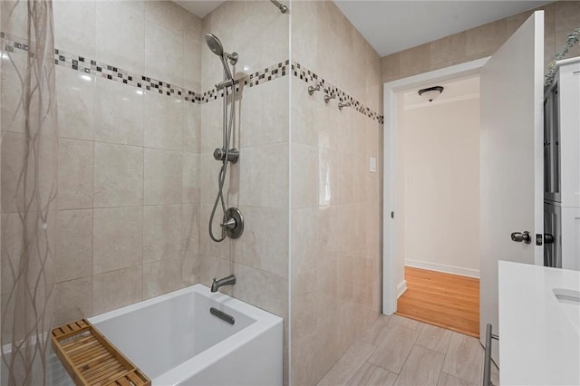 bathroom with wood finished floors, bathtub / shower combination, and vanity