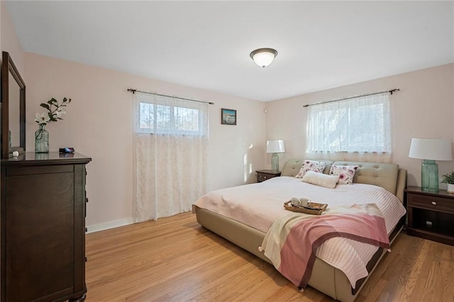 bedroom featuring baseboards and light wood-style flooring