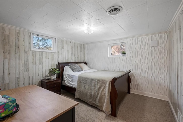 bedroom with visible vents, ornamental molding, baseboards, and carpet floors