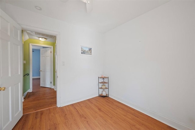 spare room featuring light wood-style flooring and baseboards