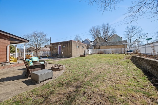 view of yard featuring an outbuilding, a patio area, and a fenced backyard