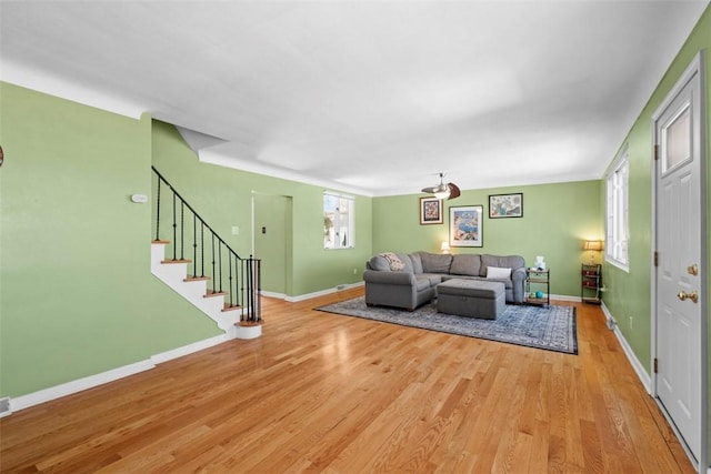 living room with light wood finished floors, stairway, and baseboards