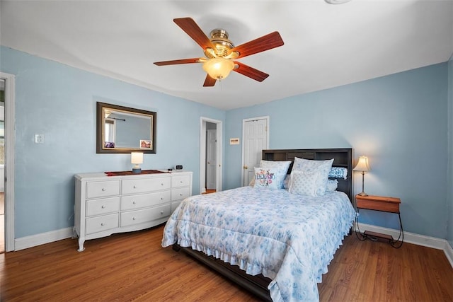 bedroom with wood finished floors, baseboards, and ceiling fan