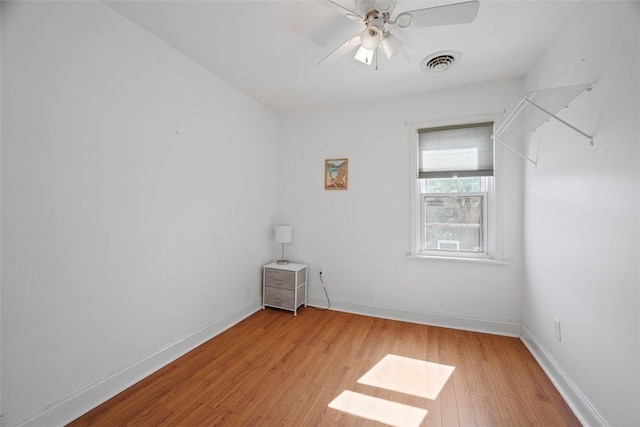 empty room with visible vents, baseboards, light wood-style floors, and ceiling fan