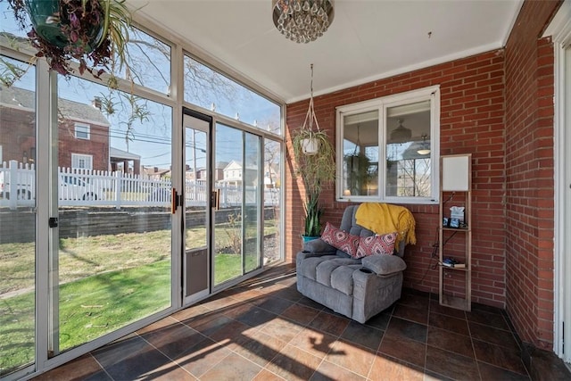 sunroom / solarium featuring a residential view