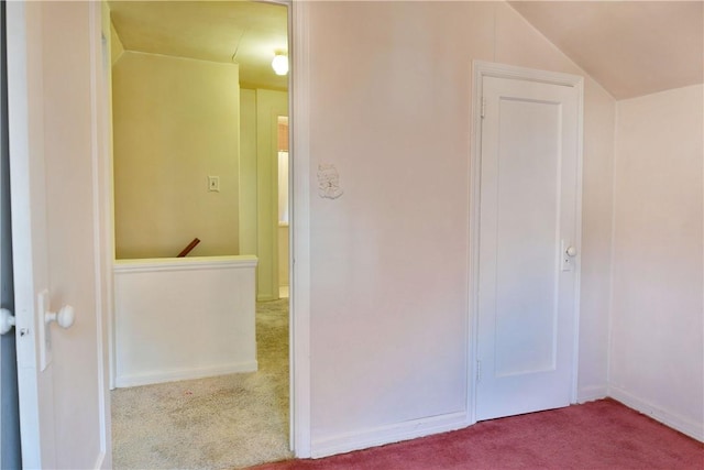 interior space with vaulted ceiling and carpet flooring