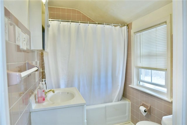 bathroom featuring shower / tub combo, tile walls, and vanity