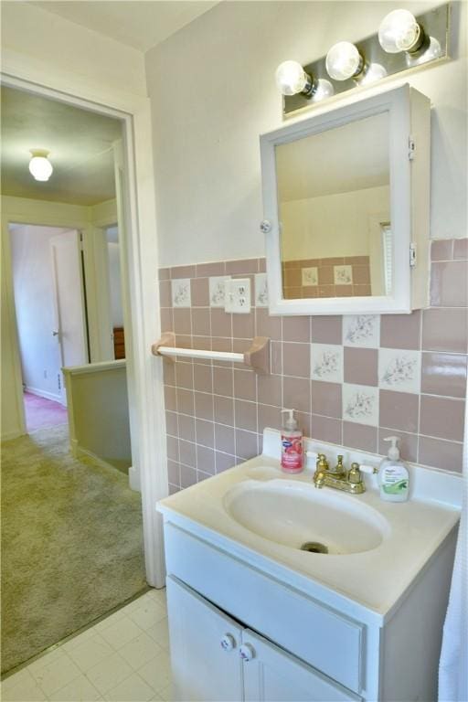 bathroom with vanity and tile walls