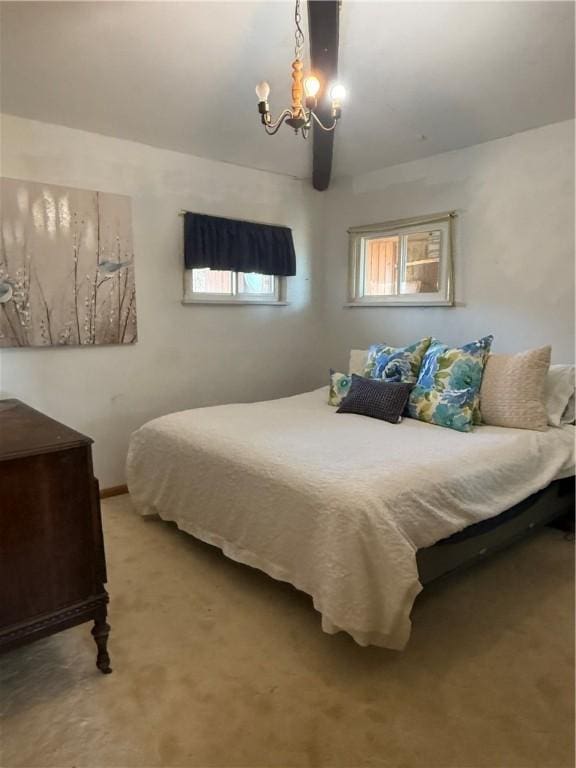 carpeted bedroom featuring a notable chandelier and multiple windows