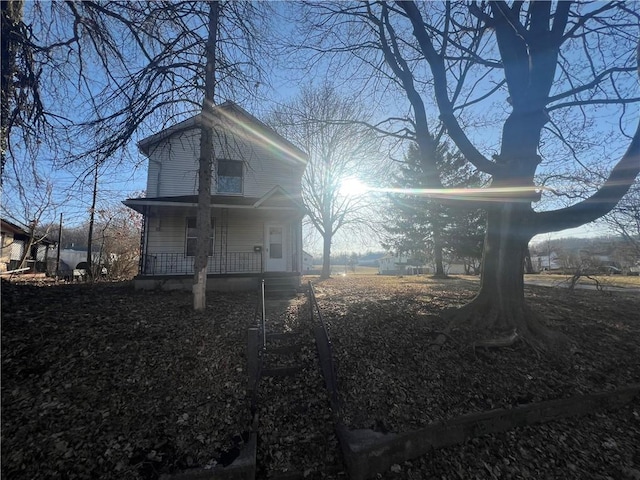 back of house featuring covered porch