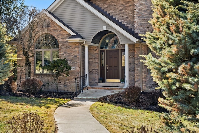 view of exterior entry with brick siding