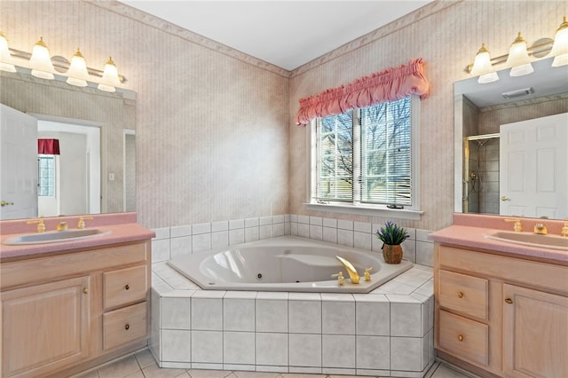 bathroom with a tub with jets, a stall shower, wallpapered walls, and a sink