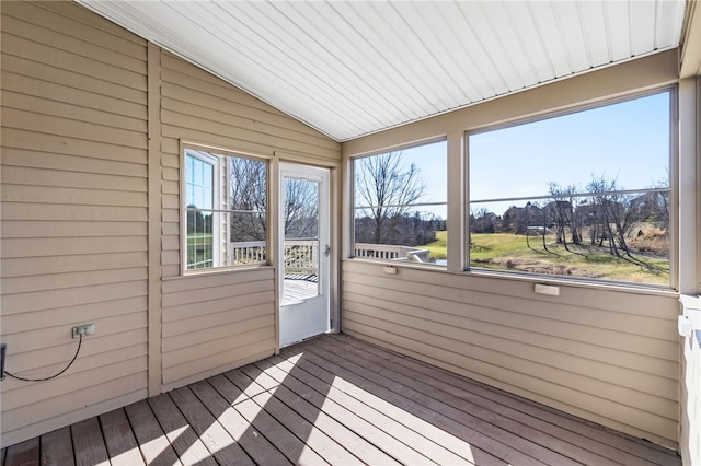 unfurnished sunroom with a healthy amount of sunlight and vaulted ceiling