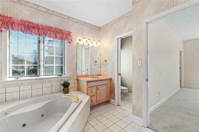 bathroom featuring vanity, baseboards, a whirlpool tub, tile patterned flooring, and toilet