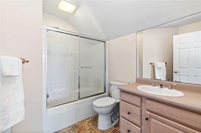 full bath with toilet, vaulted ceiling, tile patterned floors, combined bath / shower with glass door, and vanity