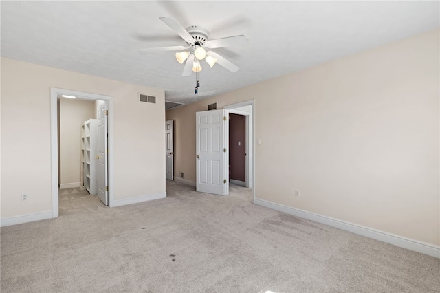 unfurnished bedroom with visible vents, baseboards, and light colored carpet