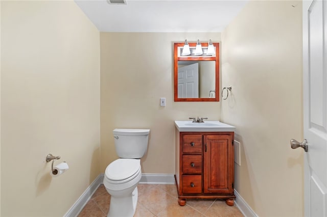 half bathroom with vanity, visible vents, baseboards, tile patterned floors, and toilet