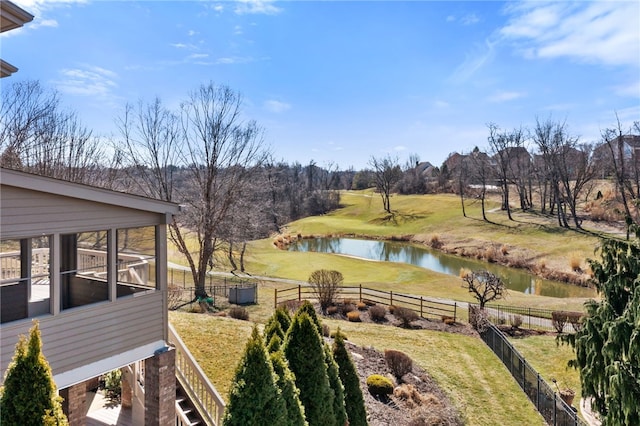 view of yard featuring fence and a water view