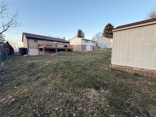 view of yard with a deck and fence