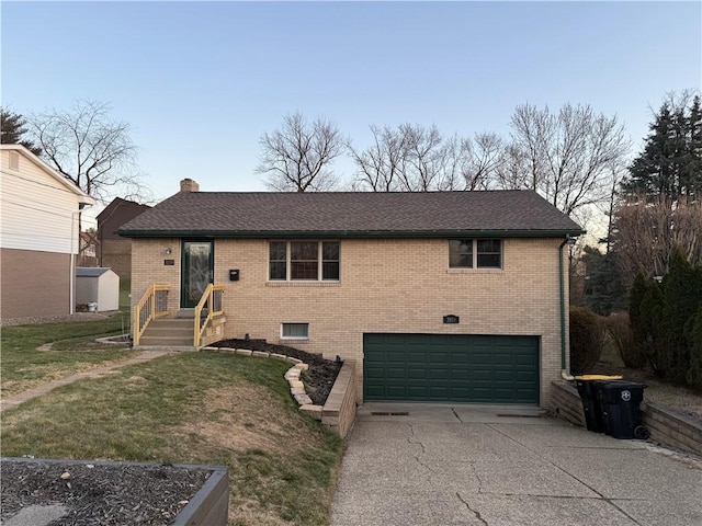 view of front facade featuring a front lawn, driveway, a garage, brick siding, and a chimney