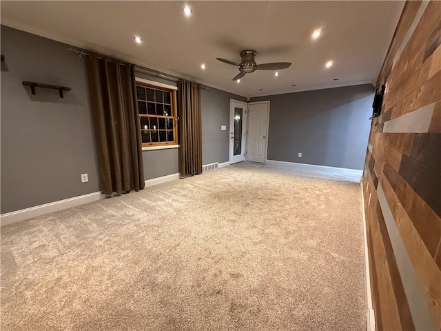 spare room featuring recessed lighting, baseboards, light carpet, and crown molding