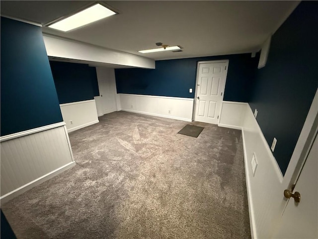 carpeted spare room with wainscoting