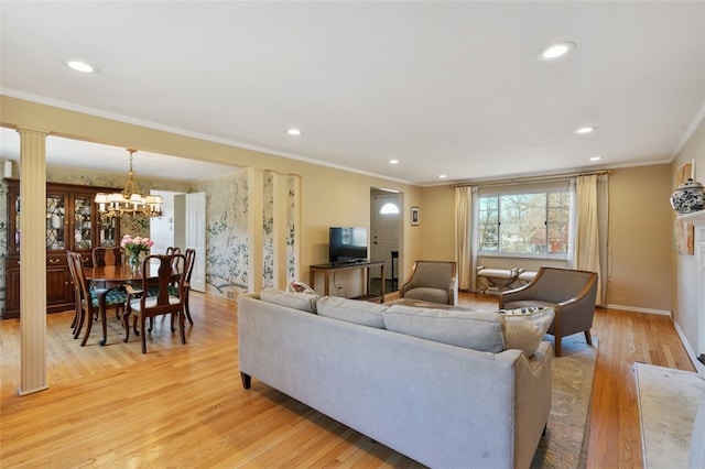 living room featuring light wood-style flooring, recessed lighting, crown molding, decorative columns, and baseboards