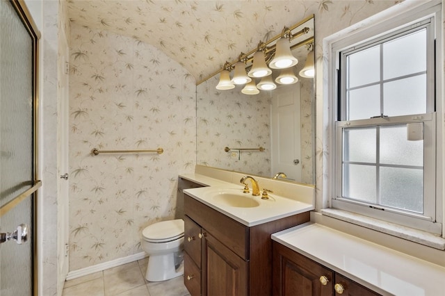 bathroom with tile patterned floors, toilet, wallpapered walls, baseboards, and vanity