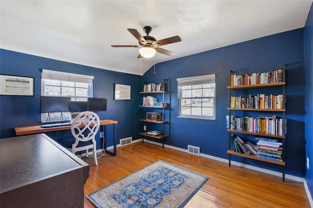 office with visible vents, a healthy amount of sunlight, and wood finished floors