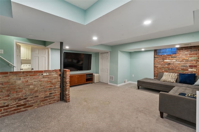 living area with recessed lighting, visible vents, light carpet, and brick wall