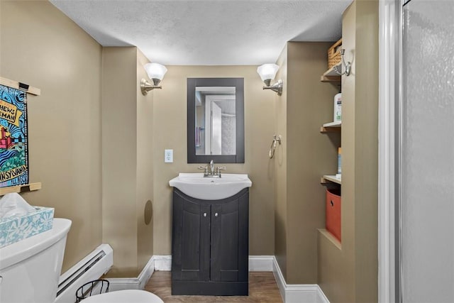 bathroom with toilet, a textured ceiling, a baseboard radiator, baseboards, and vanity