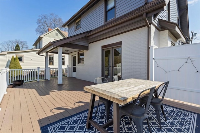 wooden deck with french doors and outdoor dining area