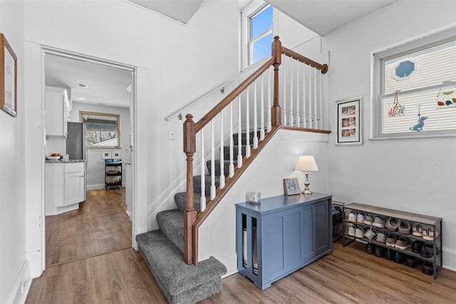 stairs featuring wood finished floors