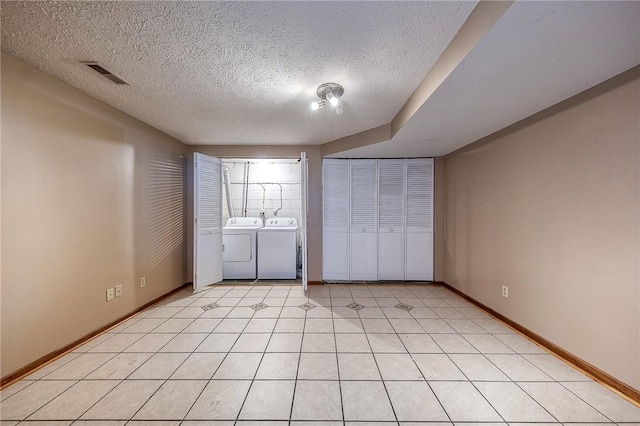 unfurnished bedroom with visible vents, baseboards, independent washer and dryer, and light tile patterned flooring