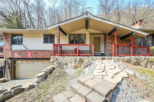 view of front of property with a garage, brick siding, and a porch