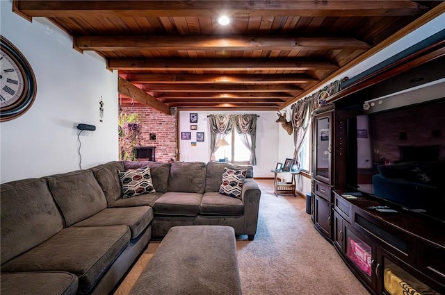 living area with light carpet, beam ceiling, a brick fireplace, and wood ceiling