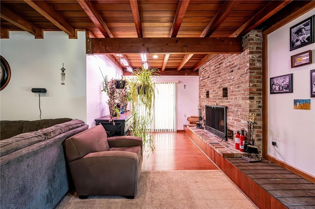 living room featuring wooden ceiling, a brick fireplace, wood finished floors, and beam ceiling