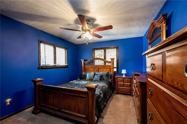 bedroom featuring a ceiling fan, carpet, baseboards, and a textured ceiling