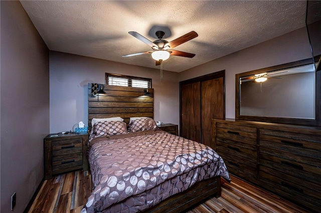 bedroom with a textured ceiling, a ceiling fan, and wood finished floors