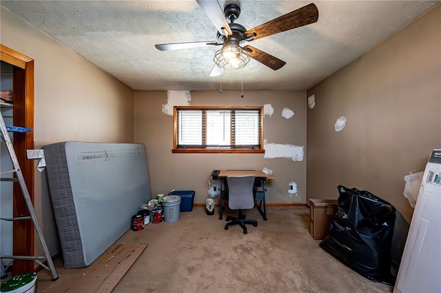 carpeted office featuring baseboards, a textured ceiling, and ceiling fan