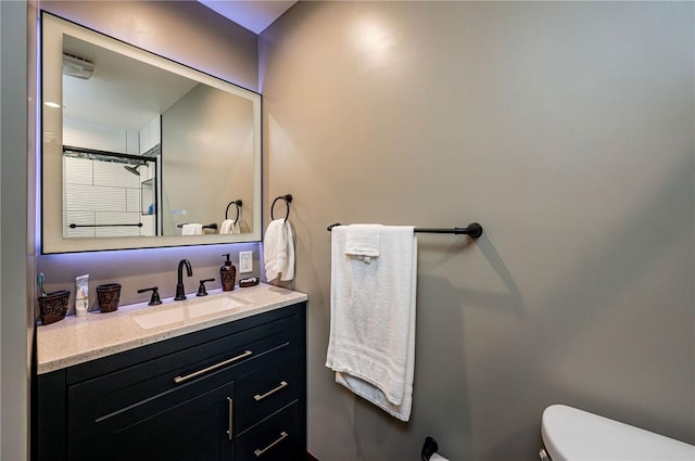 bathroom featuring toilet and vanity