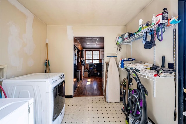 washroom with laundry area, separate washer and dryer, and light floors