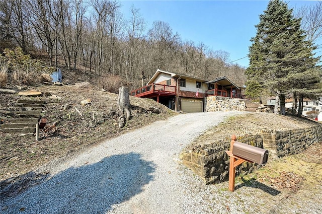 view of front facade with stairway, driveway, and an attached garage