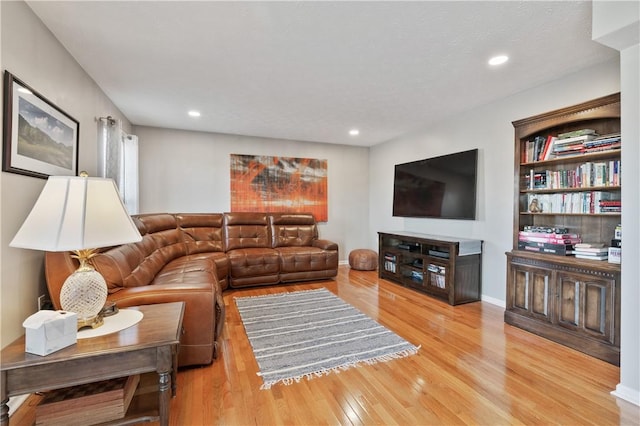 living room with recessed lighting, baseboards, and wood finished floors