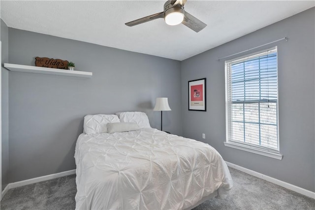 bedroom with carpet flooring, a ceiling fan, and baseboards