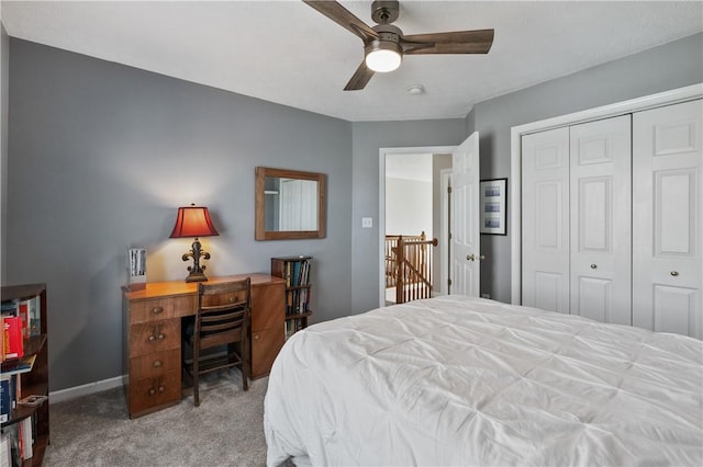 bedroom with a ceiling fan, baseboards, a closet, and carpet floors