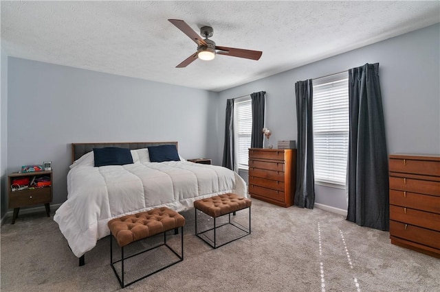 bedroom with baseboards, carpet floors, a textured ceiling, and ceiling fan