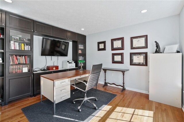 office area with light wood-style flooring, recessed lighting, and baseboards